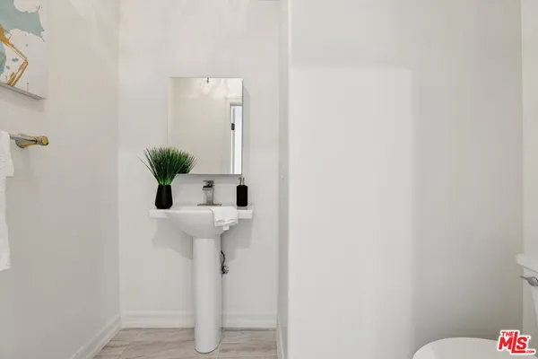 a bathroom with a sink mirror and toilet