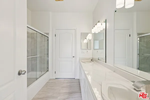 a bathroom with a sink and vanity