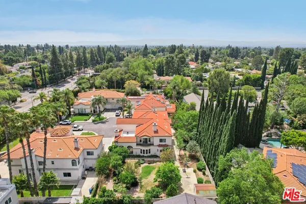 an aerial view of a house with a yard swimming pool and outdoor seating
