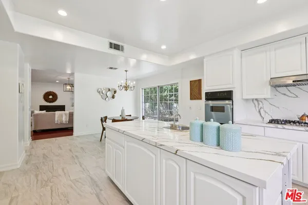 a view of living room with granite countertop furniture and fireplace