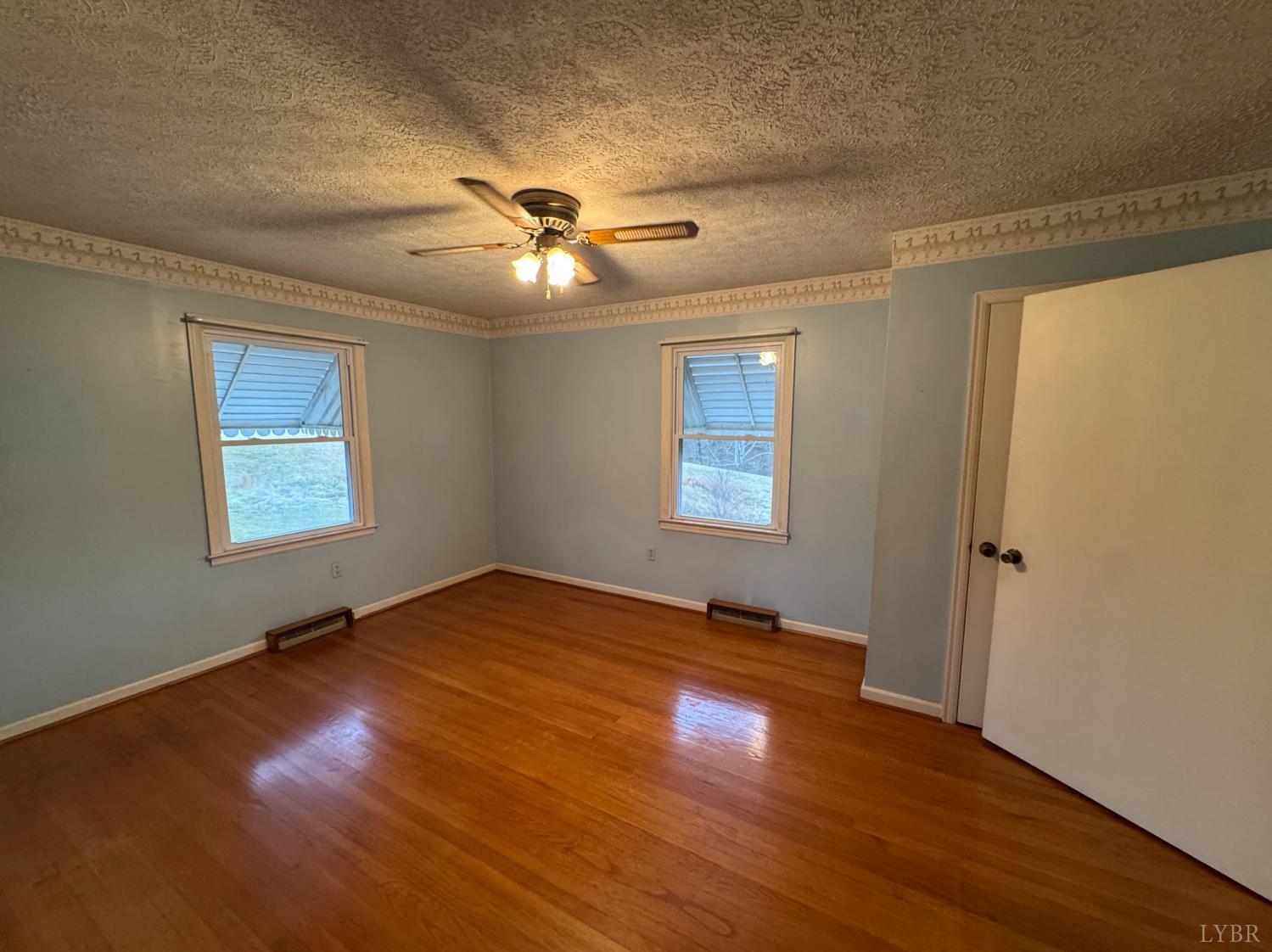 126 Rothwood Road Monroe, VA 24574 - Photo 6 of 21 a view of an empty room with a window and wooden floor