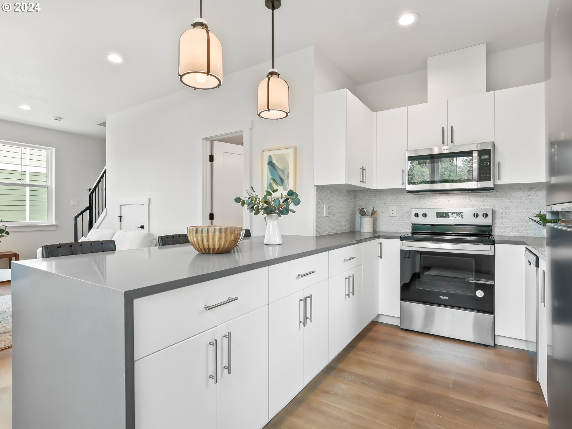 4636 Northeast Sumner Street Portland, OR 97218 - Photo 12 of 39 a kitchen with kitchen island granite countertop a sink a stove and cabinets