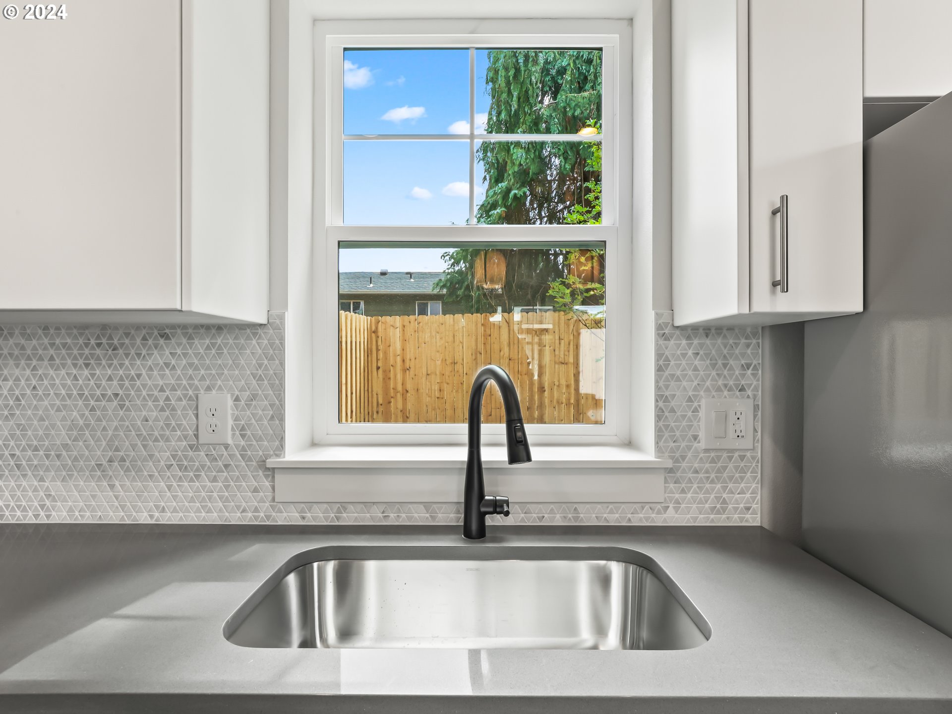 4636 Northeast Sumner Street Portland, OR 97218 - Photo 13 of 39 a kitchen with a sink and a window