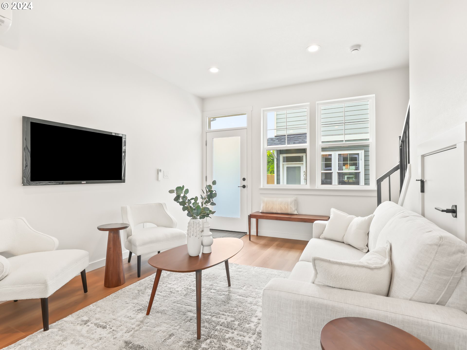 4636 Northeast Sumner Street Portland, OR 97218 - Photo 16 of 39 a living room with furniture a flat screen tv and a floor to ceiling window