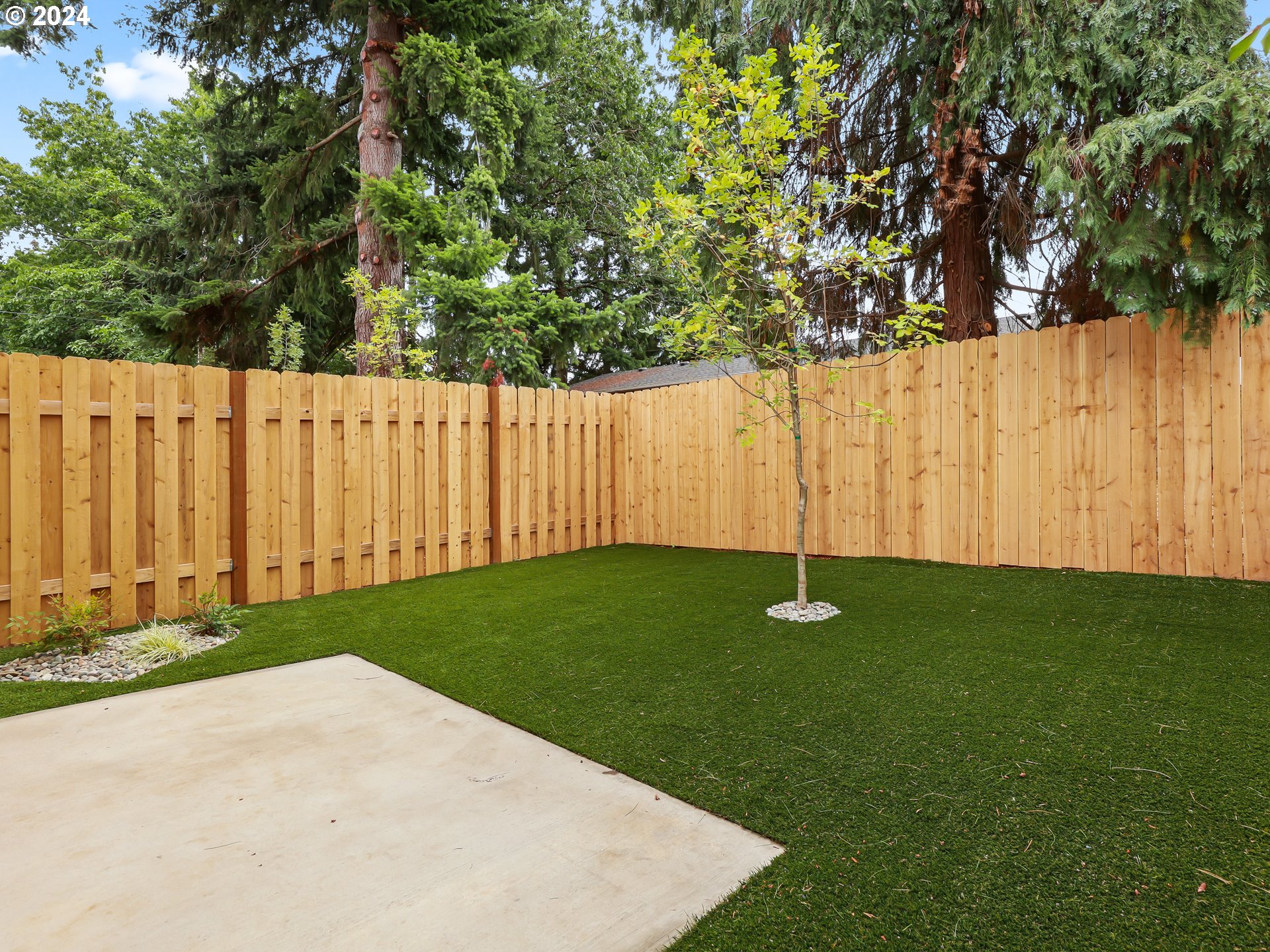 4636 Northeast Sumner Street Portland, OR 97218 - Photo 34 of 39 a view of a yard with wooden fence