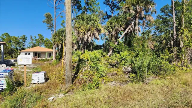 a view of a patio with table and chairs under an umbrella