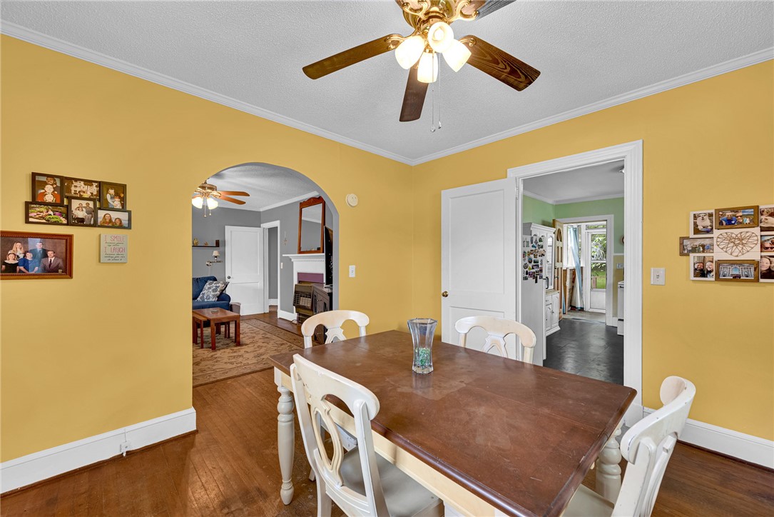 102 Graham Honea Path, SC 29654 - Photo 9 of 29 Rich hardwood floors complement this cozy dining space, opening into an inviting living area and bright kitchen beyond.