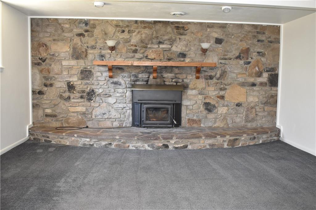659 Ann Roberts Road Ligonier, PA 15658 - Photo 15 of 21 Family room- Beautiful stone fireplace with wood burning insert to help offset heating costs.