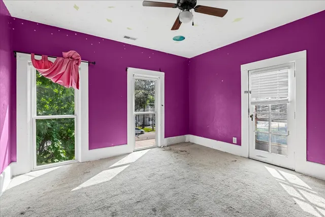 a view of a livingroom with a ceiling fan and a window