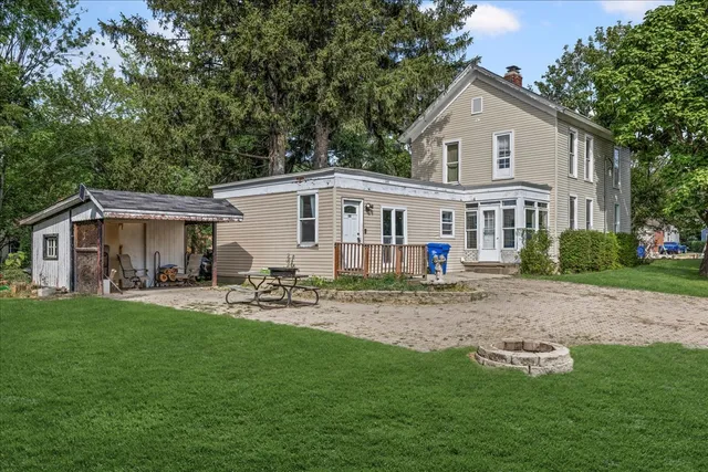a view of a house with a yard and sitting area