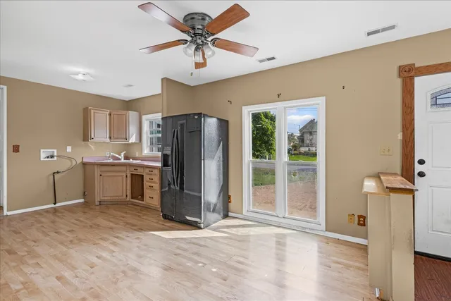 a view of a kitchen with a refrigerator and a sink