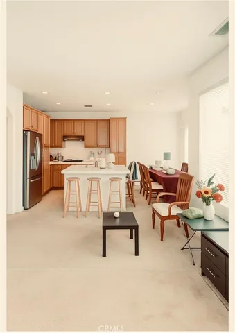 a living room with stainless steel appliances kitchen island granite countertop furniture and a kitchen view