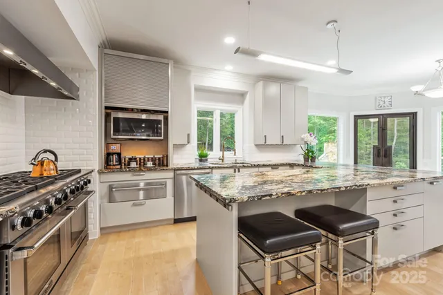 a spacious bedroom with a bed a couch and a flat screen tv