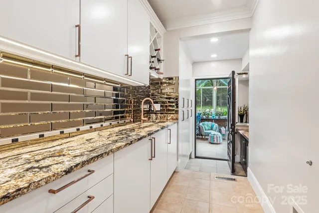 a bathroom with a granite countertop sink a mirror and a shower