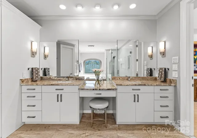 a bathroom with a granite countertop sink mirror and toilet