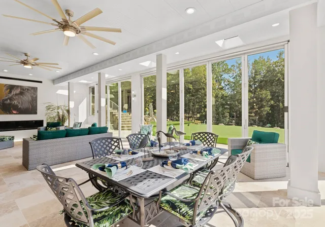 a view of a room with lots of wooden furniture and windows