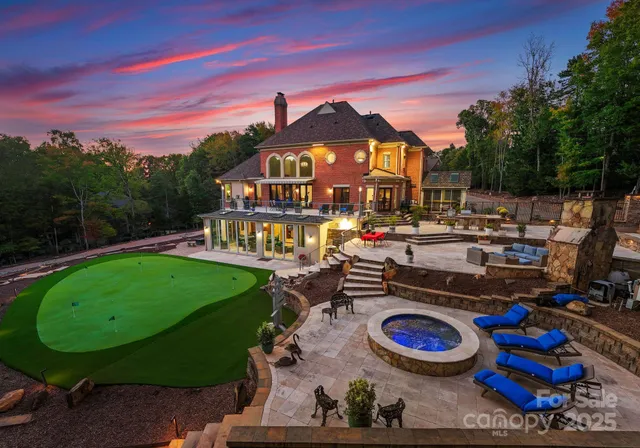 a view of a workspace with furniture and a large window