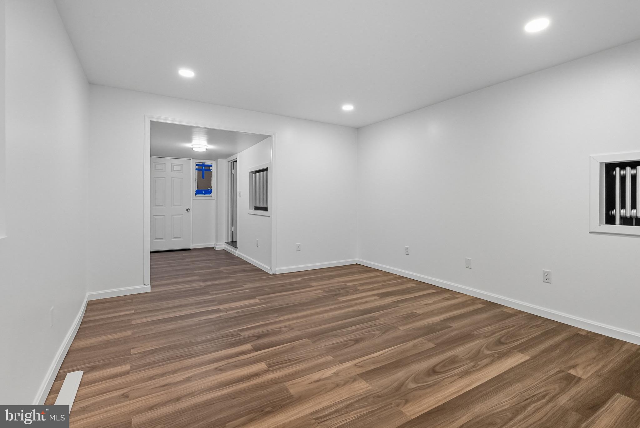 604 East 33rd Street Baltimore, MD 21218 - Photo 16 of 22 a view of empty room with wooden floor