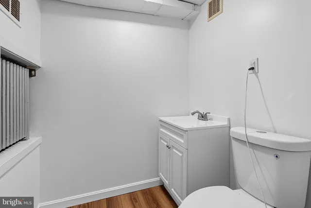 a bathroom with a sink a toilet and a mirror