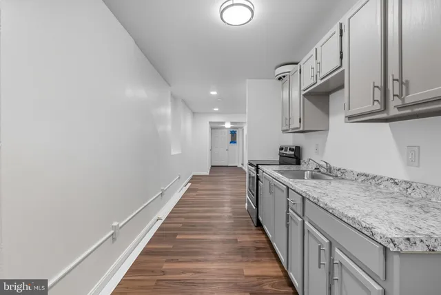 a kitchen with granite countertop sink stainless steel appliances and cabinets