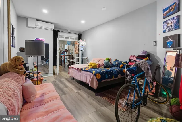 a bed room with furniture and a flat screen tv