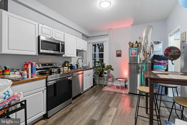 a kitchen with stainless steel appliances granite countertop a refrigerator stove microwave and sink