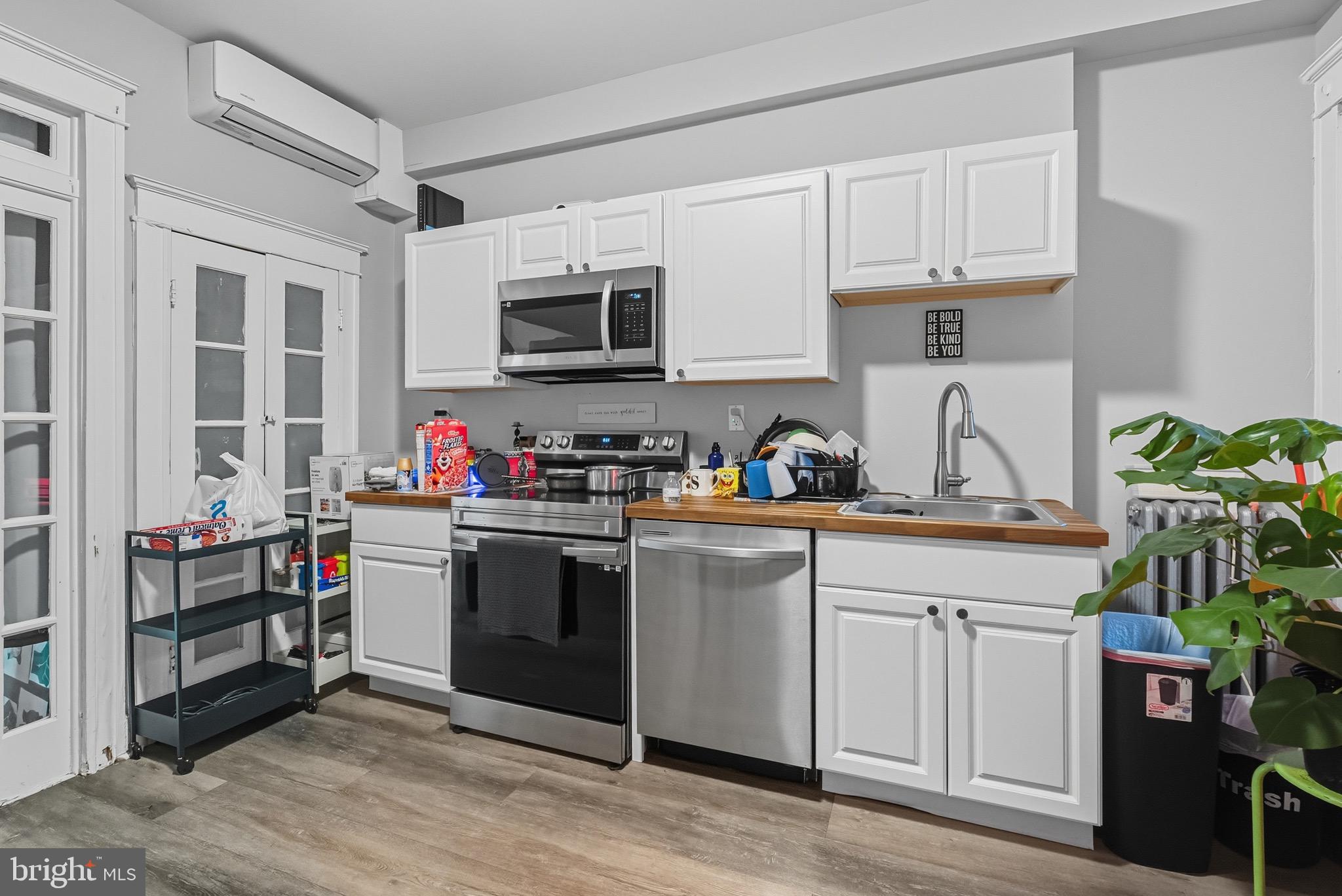 604 East 33rd Street Baltimore, MD 21218 - Photo 9 of 22 a kitchen with stainless steel appliances granite countertop a stove and a refrigerator