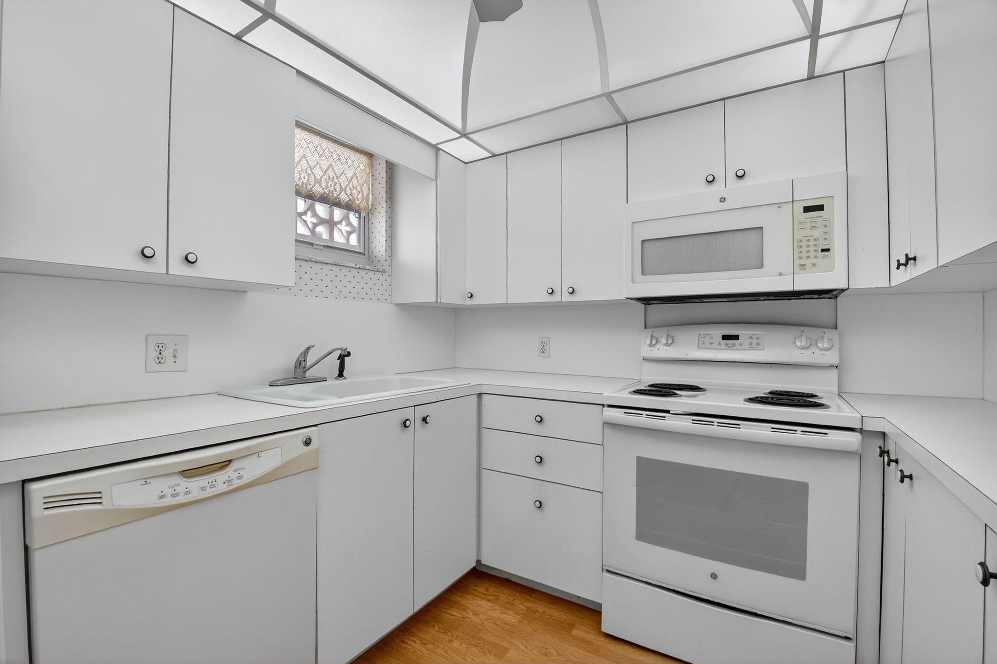 3570 South Ocean Boulevard, Unit 508 South Palm Beach, FL 33480 - Photo 14 of 47 a kitchen with cabinets appliances a sink and a counter top