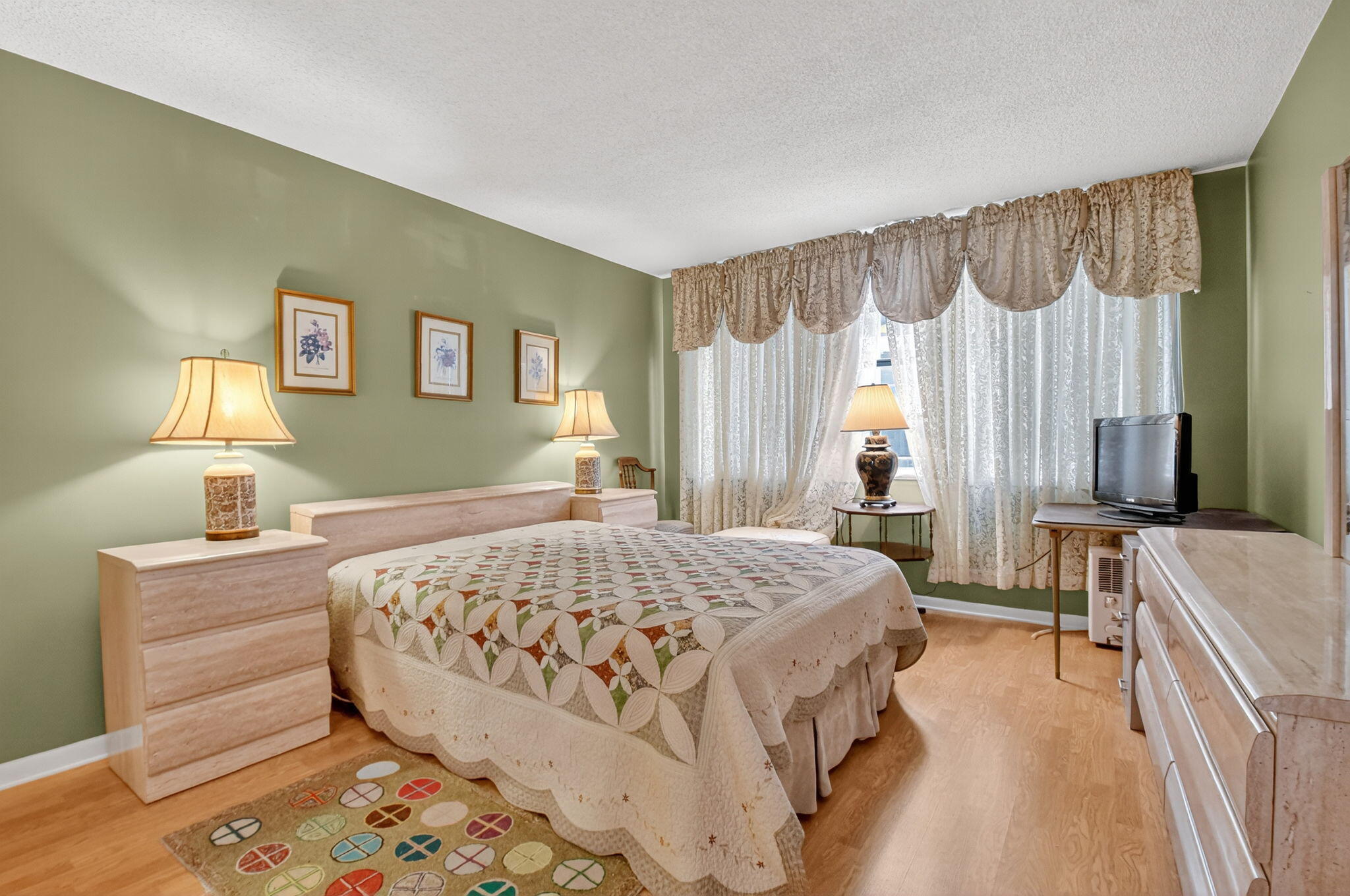 3570 South Ocean Boulevard, Unit 508 South Palm Beach, FL 33480 - Photo 20 of 47 a bedroom with a bed and a chandelier