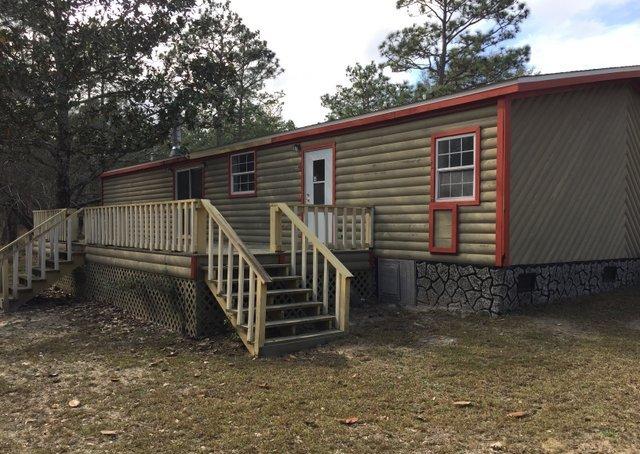 350 Robbins Road DeFuniak Springs, FL 32433 - Photo 11 of 13 a view of a house with a yard