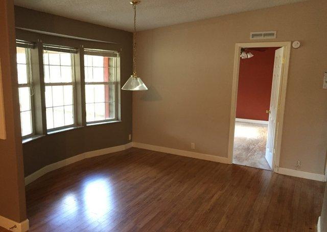 350 Robbins Road DeFuniak Springs, FL 32433 - Photo 3 of 13 an empty room with wooden floor and windows