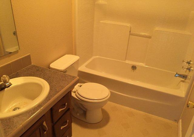 350 Robbins Road DeFuniak Springs, FL 32433 - Photo 9 of 13 a bathroom with a granite countertop toilet sink and mirror