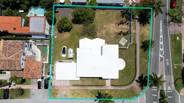 an aerial view of a house with a yard basket ball court and outdoor seating