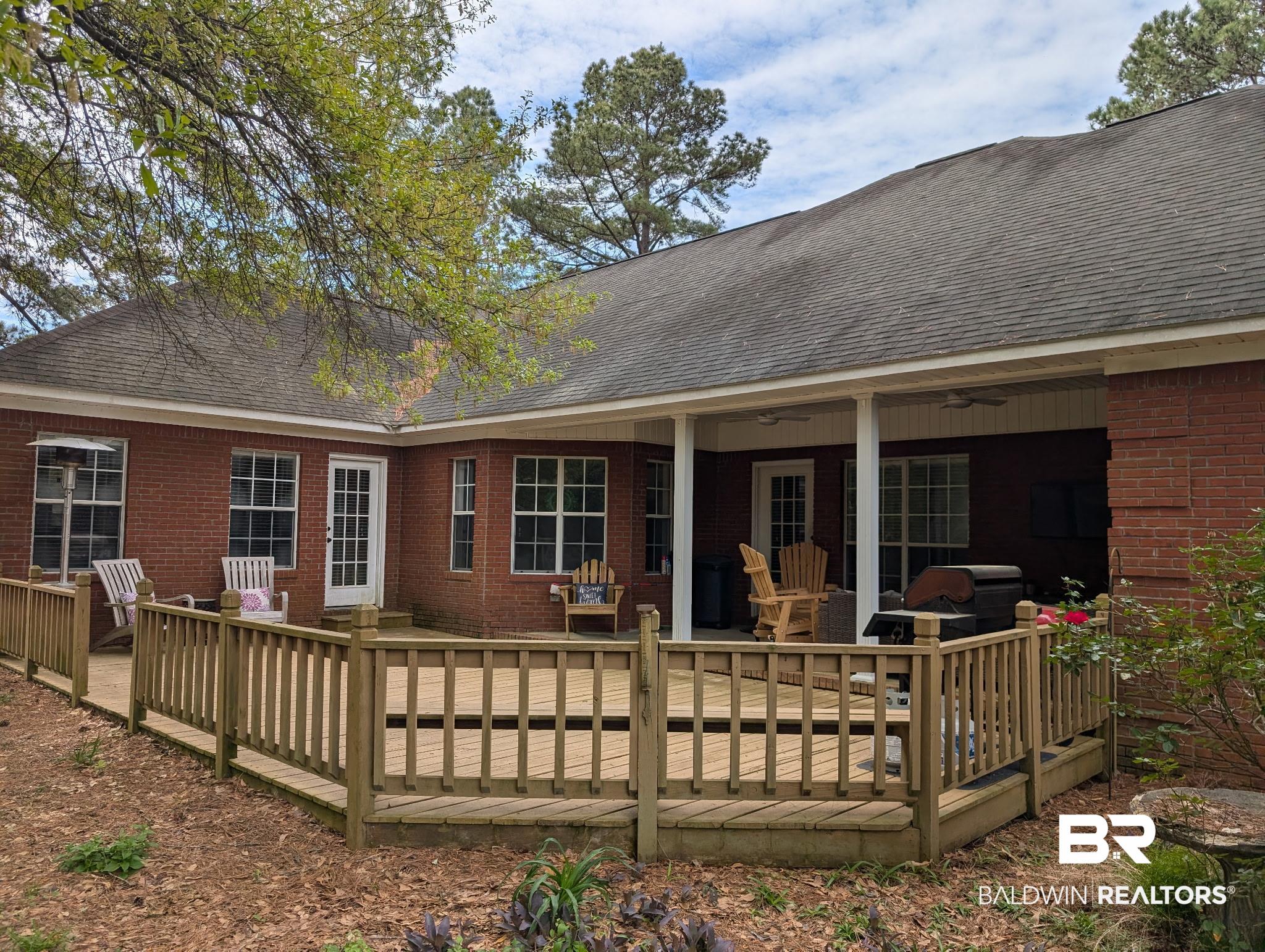 506 Old Castleberry Road Brewton, AL 36426 - Photo 12 of 14 Back of property featuring brick siding, ceiling fan, a wooden deck, and roof with shingles
