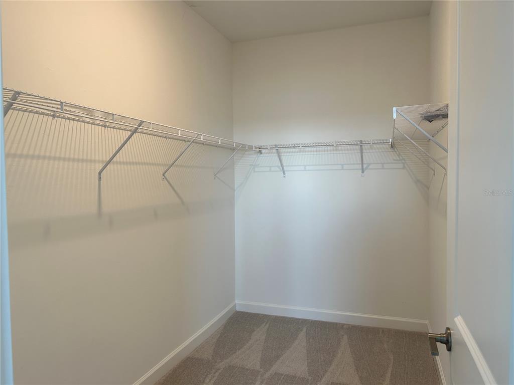15513 White Linen Drive Lakewood Ranch, FL 34211 - Photo 11 of 35 a view of a room with racks on the wall