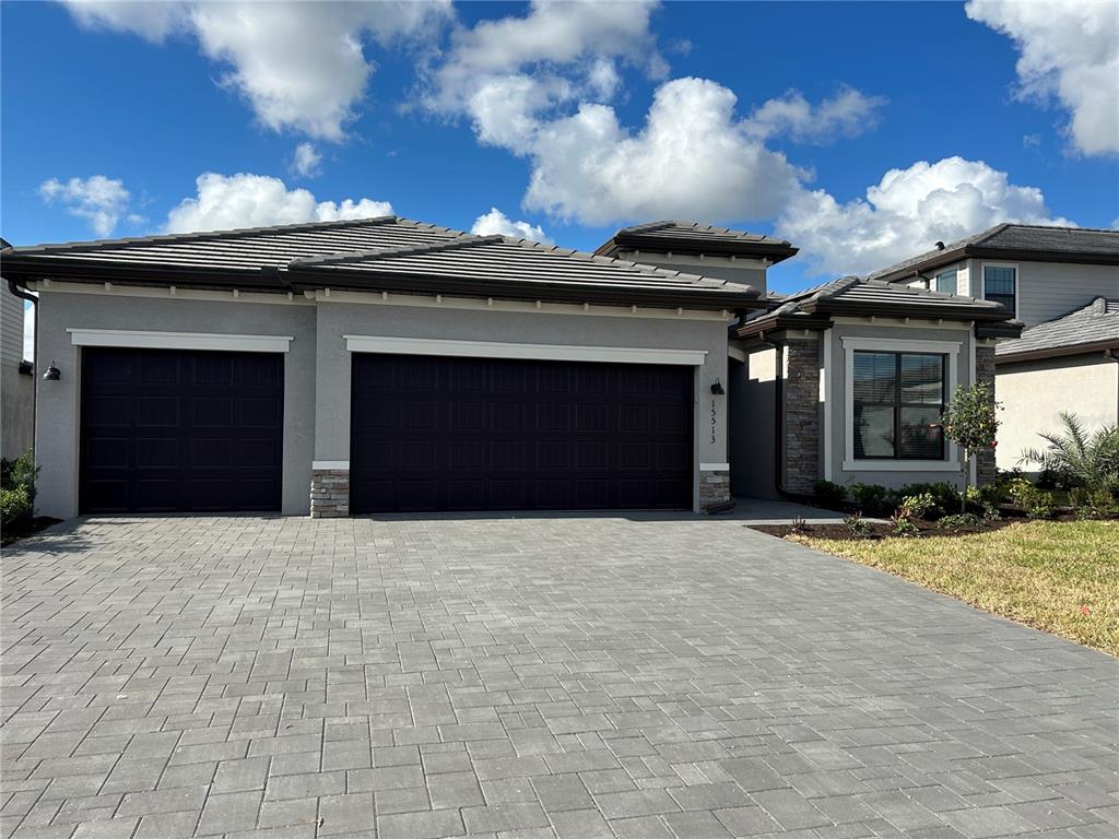 15513 White Linen Drive Lakewood Ranch, FL 34211 - Photo 2 of 35 a view of a house with a garage and a fireplace