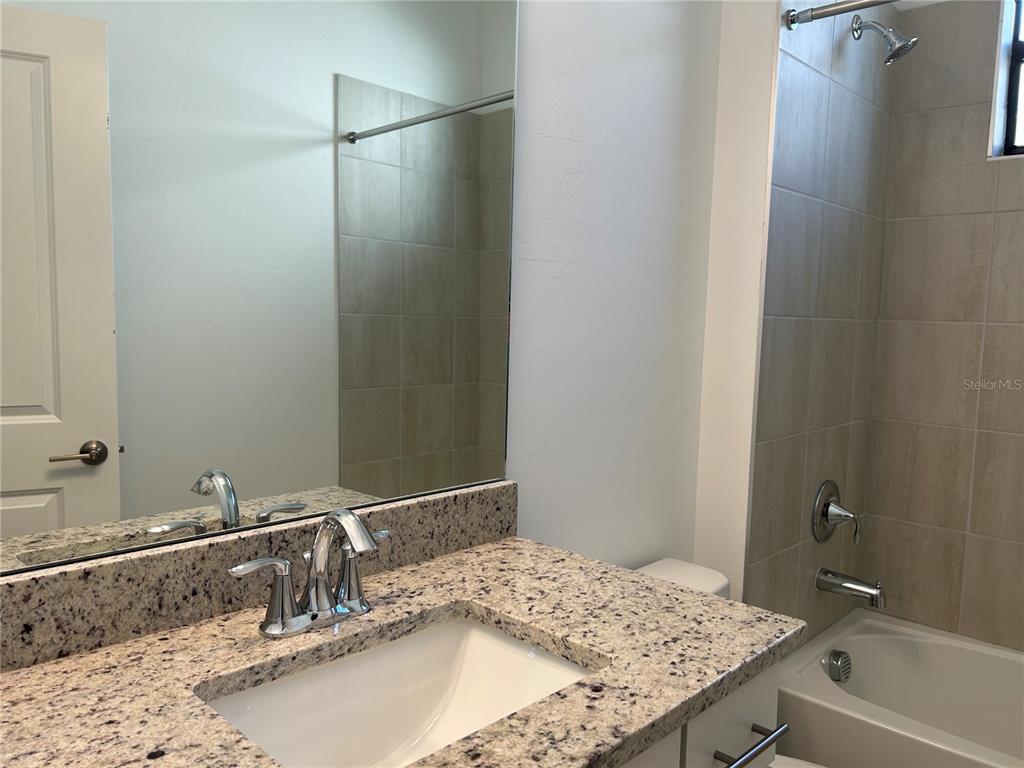 15513 White Linen Drive Lakewood Ranch, FL 34211 - Photo 23 of 35 a bathroom with a granite countertop sink and a mirror