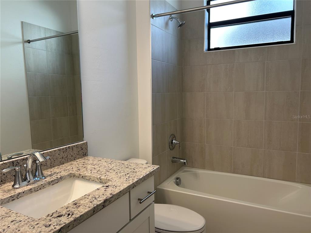 15513 White Linen Drive Lakewood Ranch, FL 34211 - Photo 30 of 35 a bathroom with a granite countertop sink toilet and shower