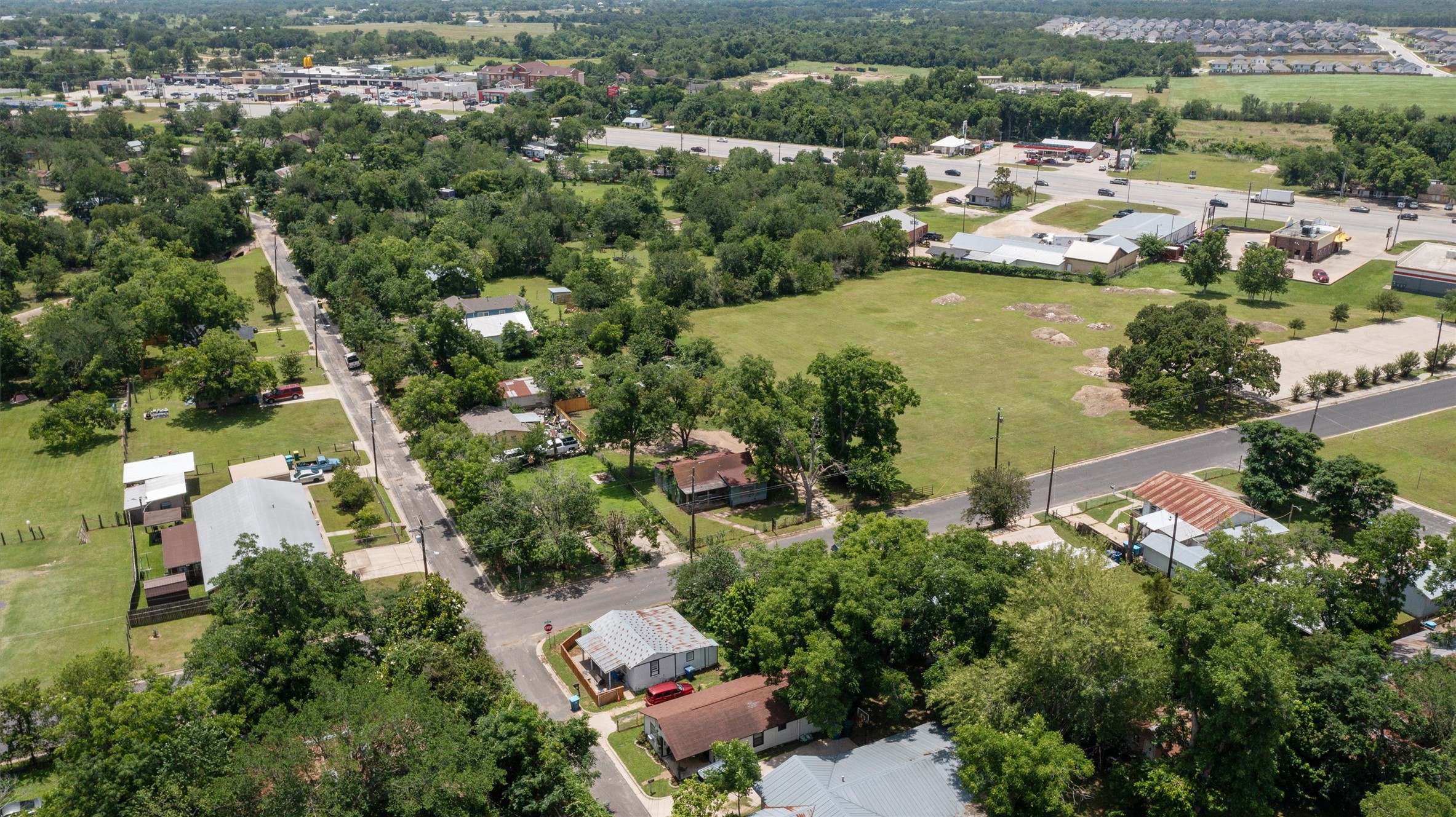 503 West Alamo Street Elgin, TX 78621 - Photo 4 of 11 an aerial view of ocean with residential house with outdoor space and river