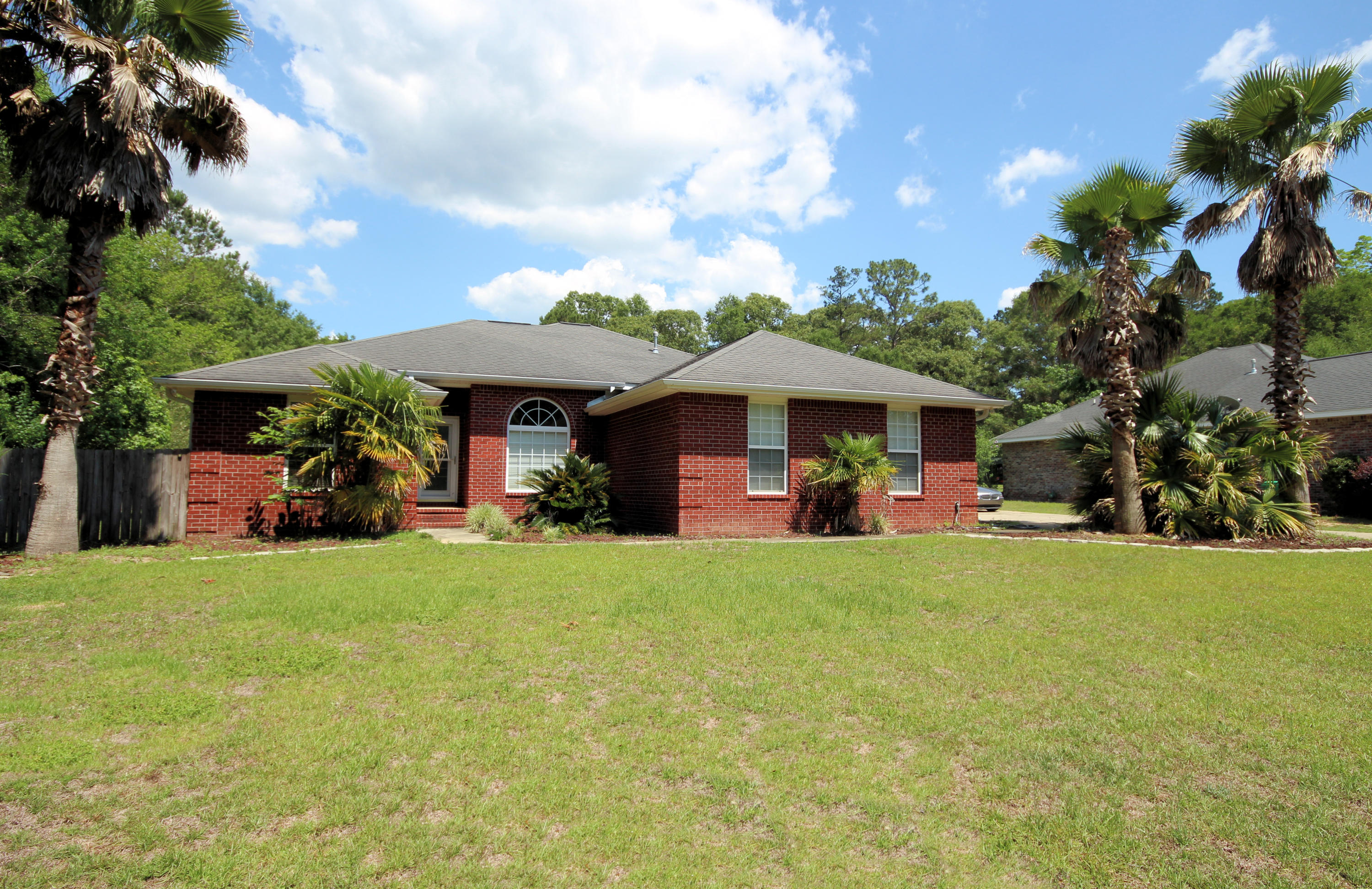 5819 Roberts Road Crestview, FL 32536 - Photo 1 of 36 a view of a table and chairs under an umbrella in front of house