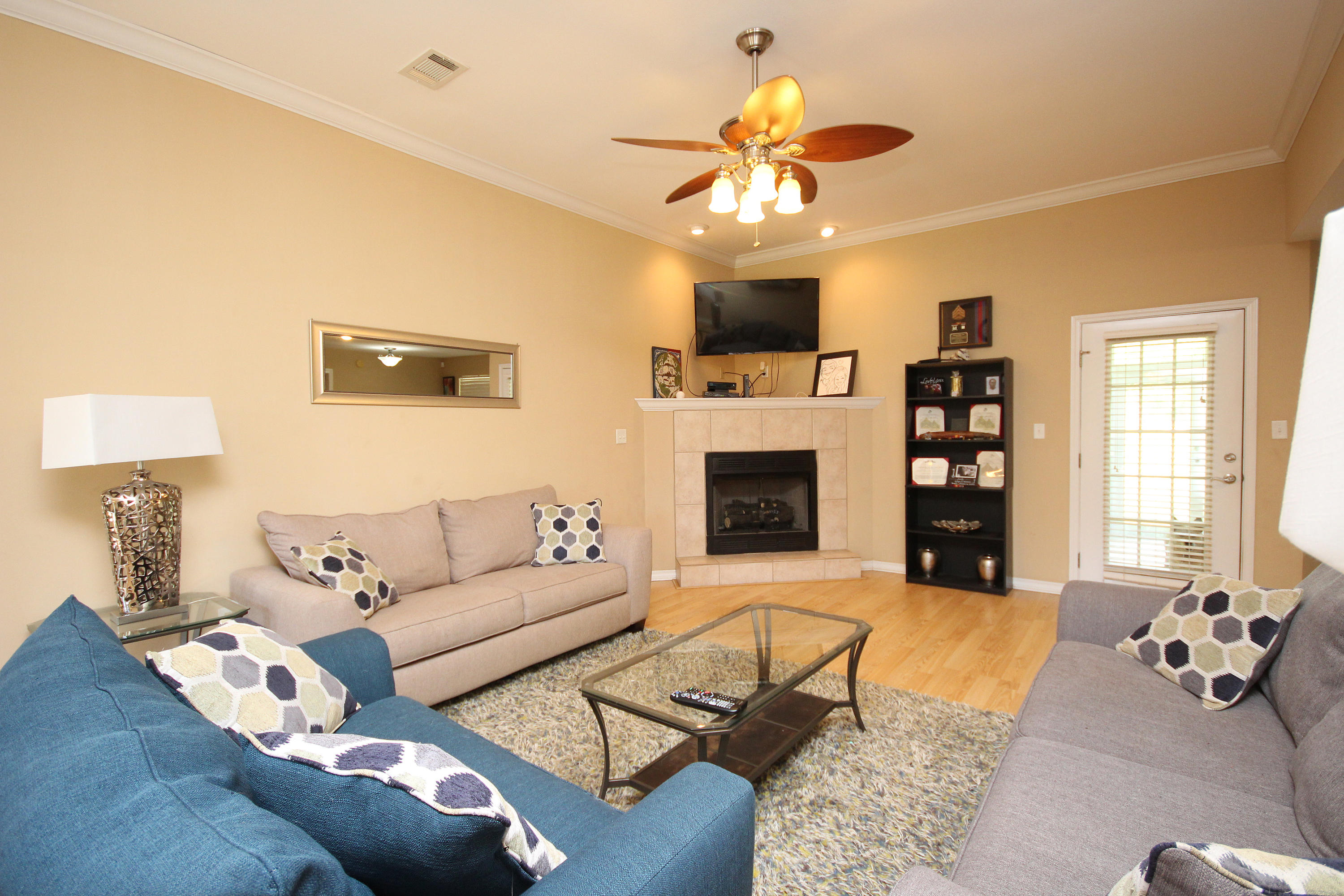 5819 Roberts Road Crestview, FL 32536 - Photo 11 of 36 a living room with furniture a chandelier and a fireplace