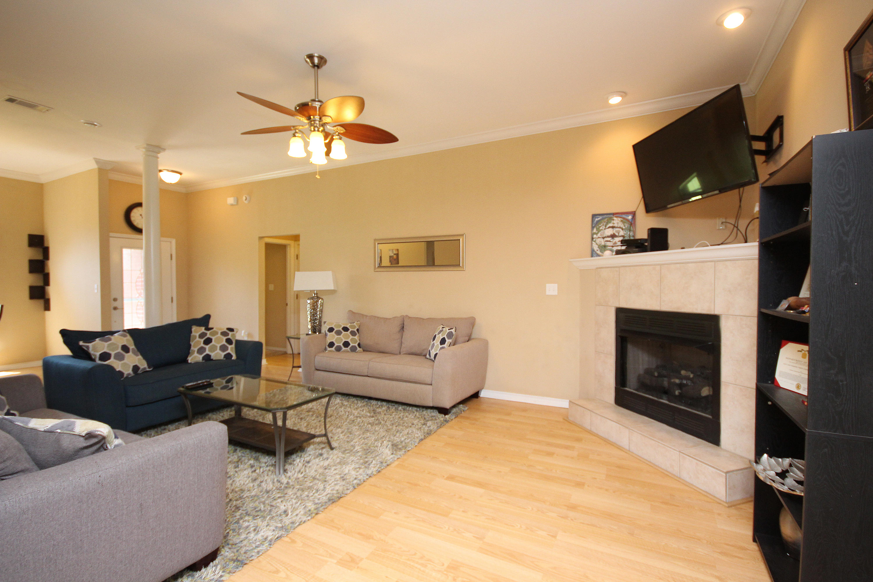 5819 Roberts Road Crestview, FL 32536 - Photo 14 of 36 a living room with furniture a fireplace and a flat screen tv