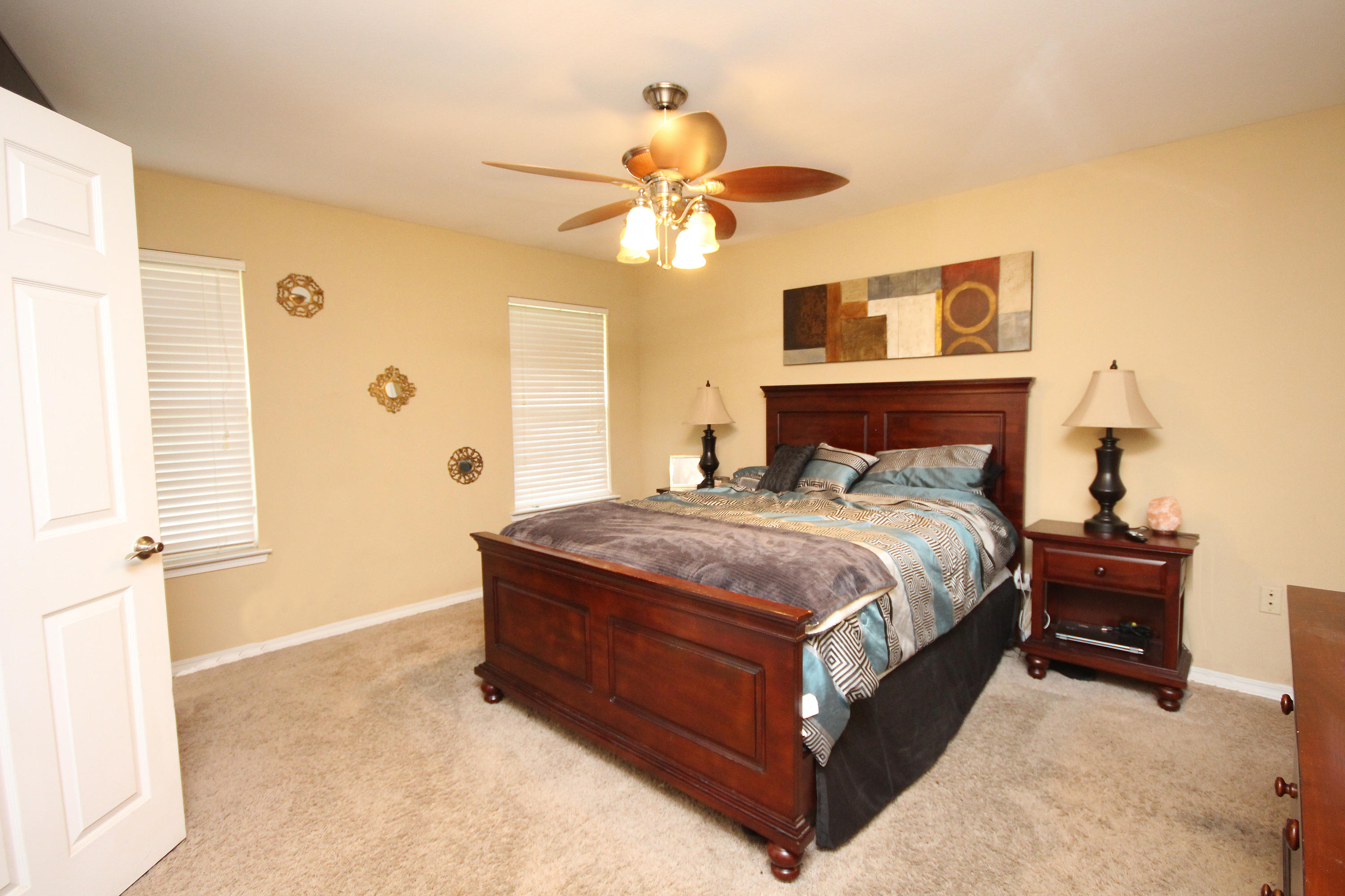 5819 Roberts Road Crestview, FL 32536 - Photo 15 of 36 a bedroom with a bed and a chandelier