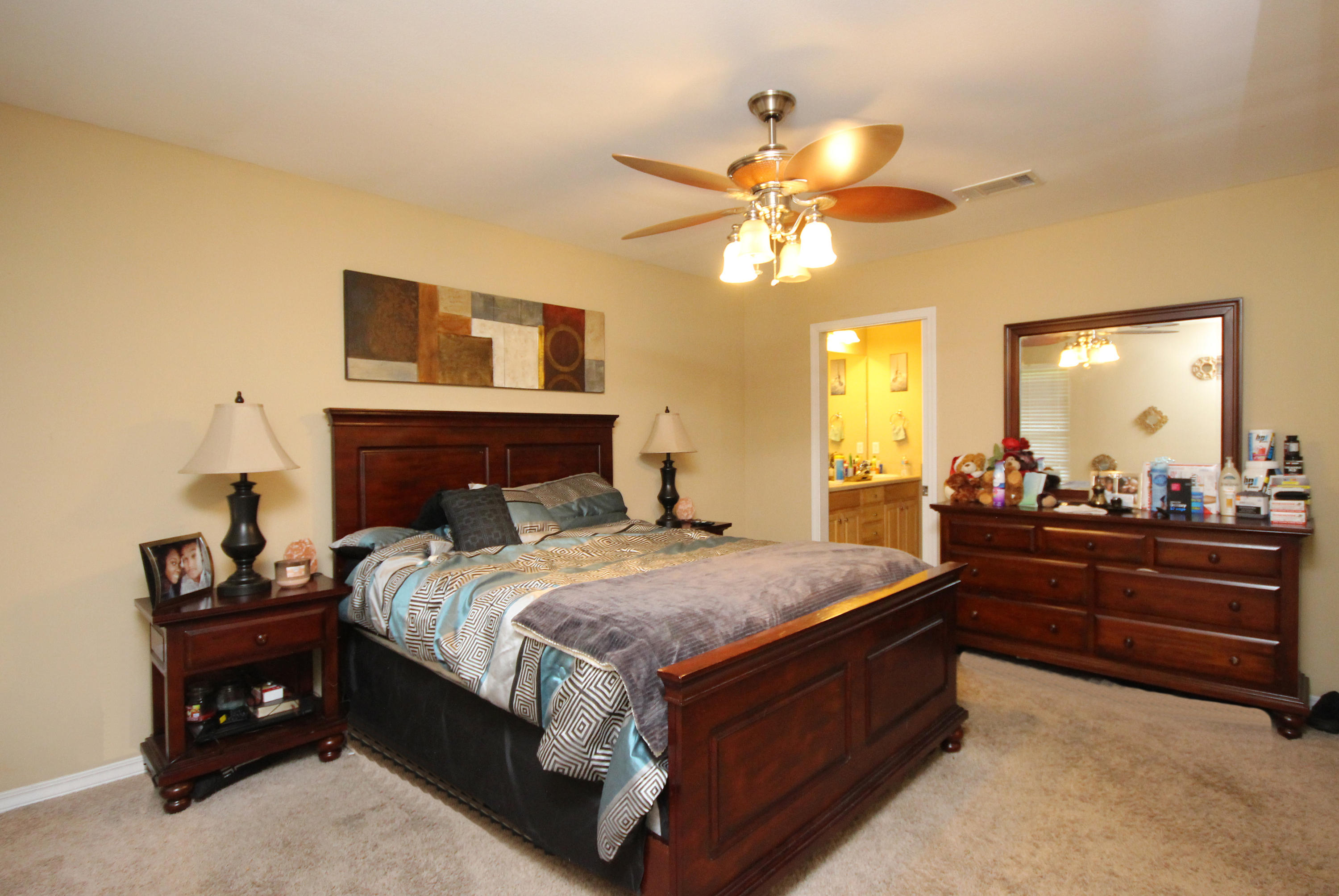 5819 Roberts Road Crestview, FL 32536 - Photo 16 of 36 a bed room with a bed and a mirror