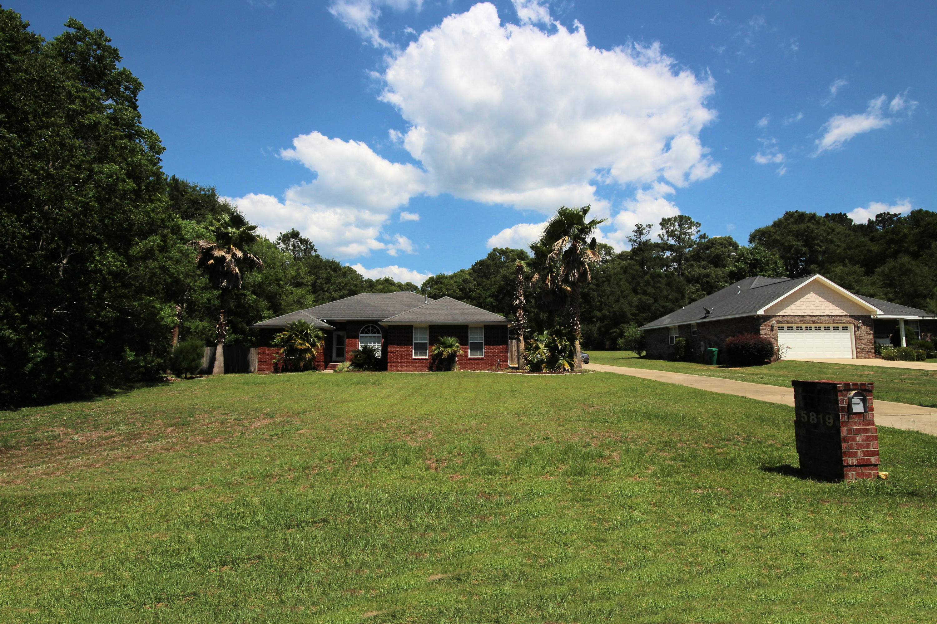 5819 Roberts Road Crestview, FL 32536 - Photo 2 of 36 a front view of a house with a garden