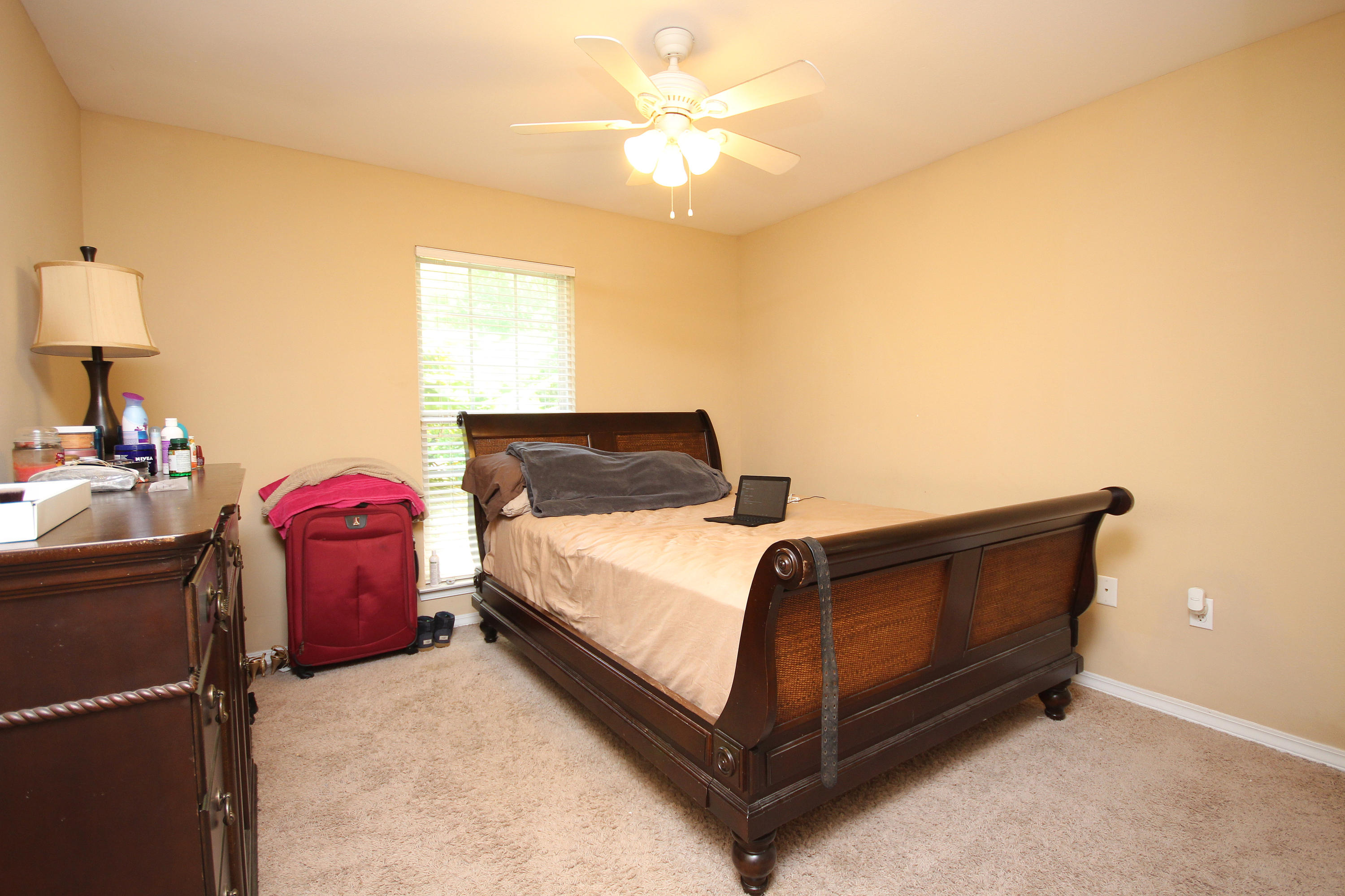 5819 Roberts Road Crestview, FL 32536 - Photo 26 of 36 a bedroom with a bed and a lamp