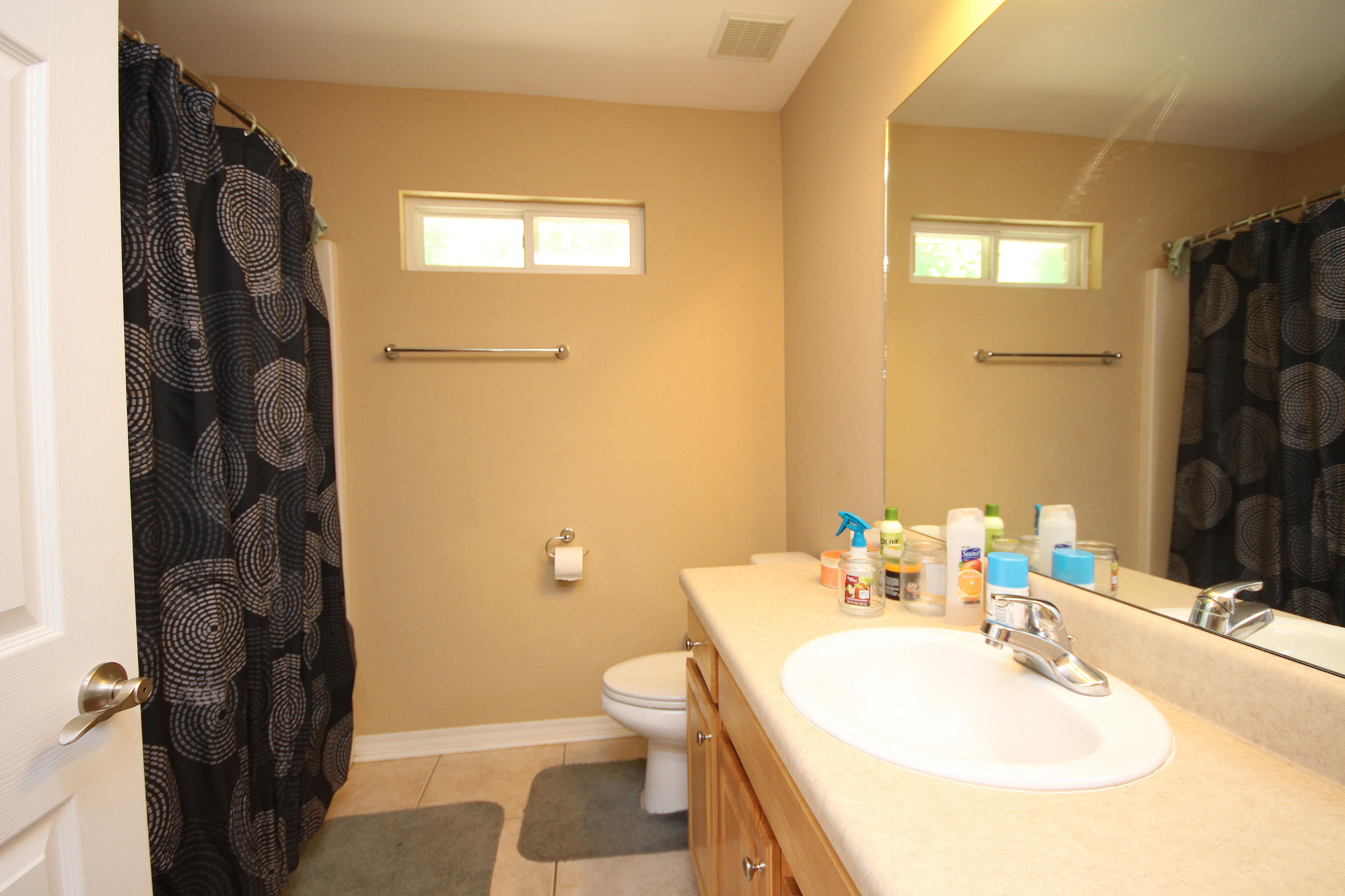 5819 Roberts Road Crestview, FL 32536 - Photo 29 of 36 a bathroom with a sink toilet and shower