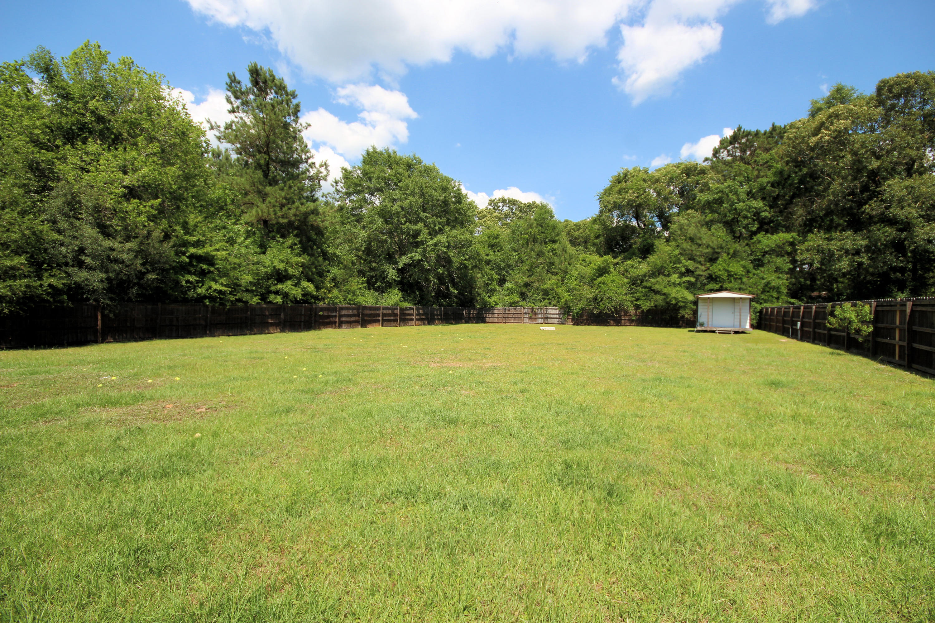5819 Roberts Road Crestview, FL 32536 - Photo 31 of 36 a view of a yard with a trees in the background