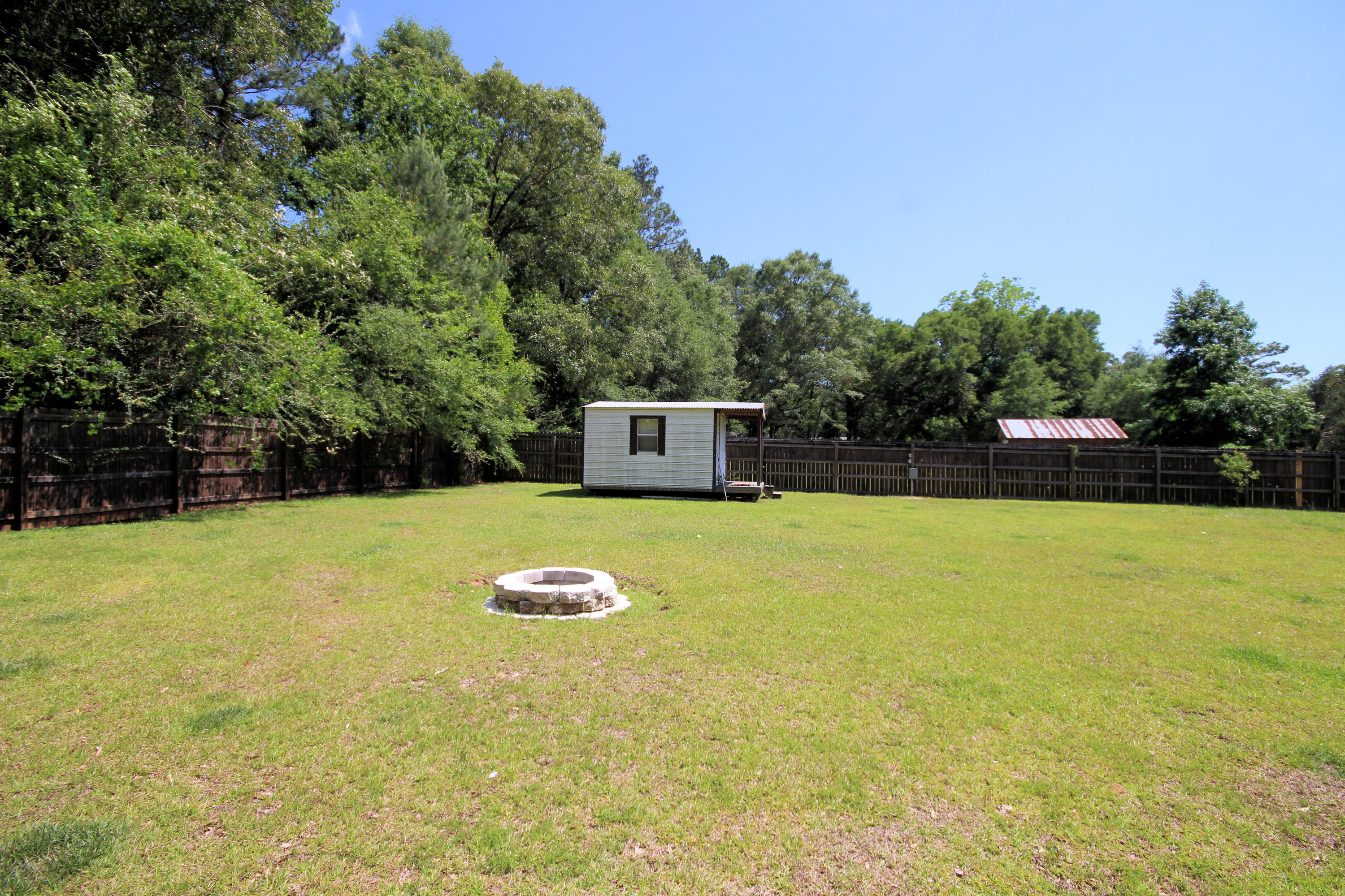 5819 Roberts Road Crestview, FL 32536 - Photo 32 of 36 a view of a swimming pool with an outdoor space and seating area