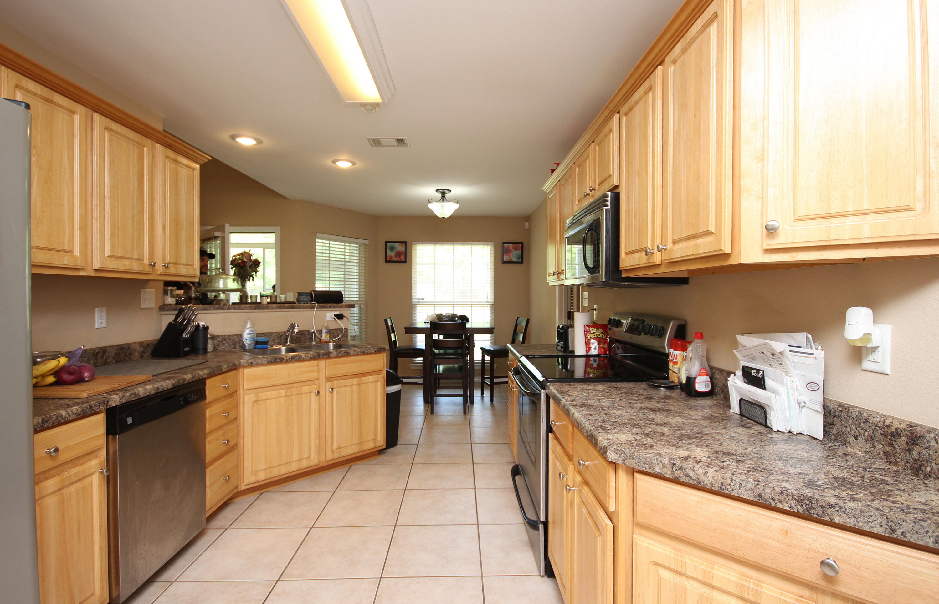 5819 Roberts Road Crestview, FL 32536 - Photo 6 of 36 a kitchen with stainless steel appliances granite countertop a stove sink and cabinets